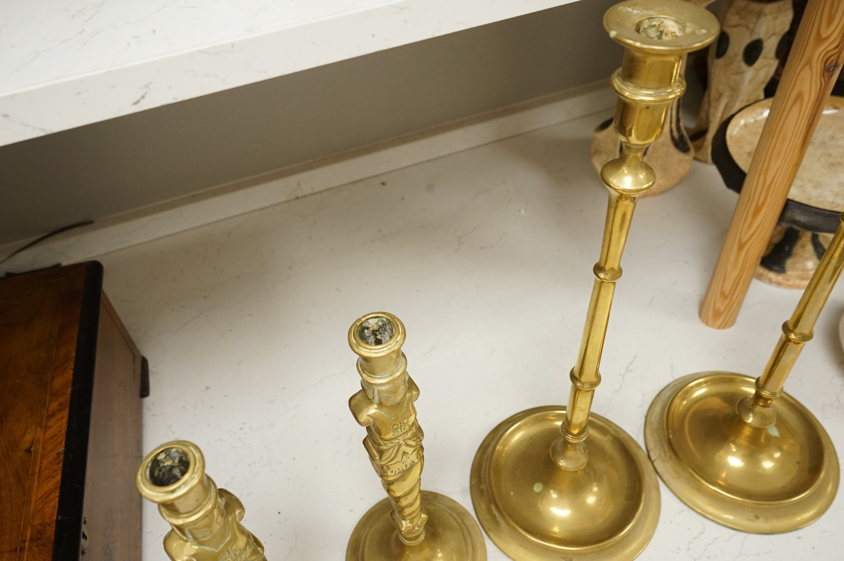 Two pairs of brass candlesticks to include a pair of figural examples, largest 47cm high